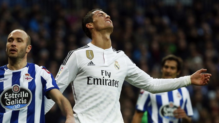 Real Madrid's Cristiano Ronaldo reacts after a missed scoring opportunity against Deportivo Coruna during their Spanish first division soccer match at Santiago Bernabeu stadium in Madrid