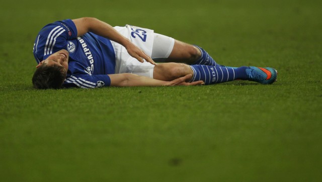 Schalke 04's Huntelaar lies on the pitch after injury during their Champions League Round of 16 first leg soccer match against Real Madrid in Gelsenkirchen