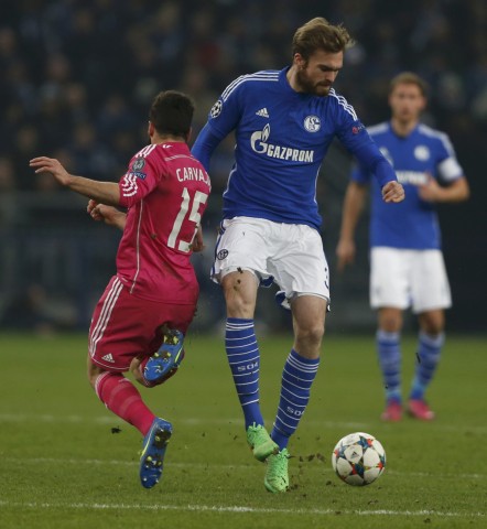 Real Madrid's Carvajal fights for the ball with Schalke 04's Kirchhoff during their Champions League Round of 16 first leg soccer match in Gelsenkirchen