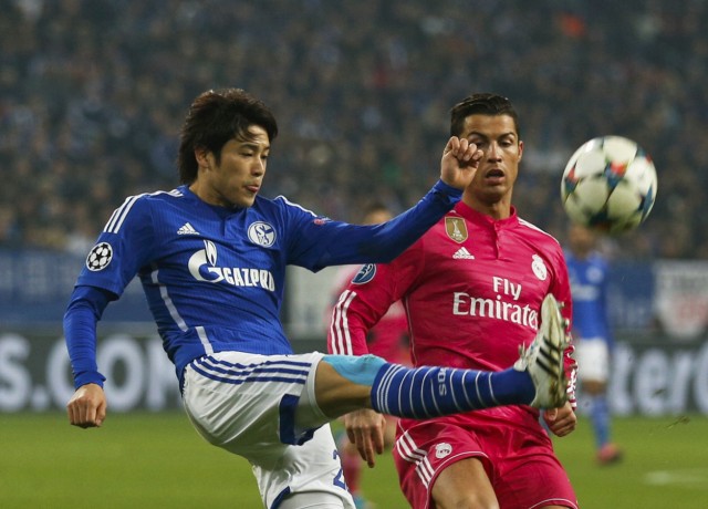 Schalke 04's Uchida kicks the ball past Real Madrid's Ronaldo during their Champions League Round of 16 first leg soccer match in Gelsenkirchen