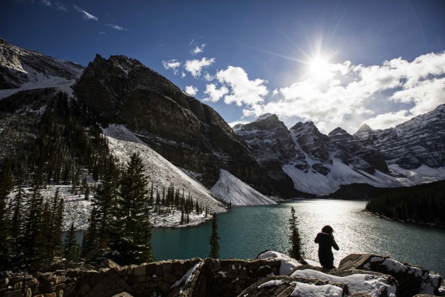 A woman looks over Moraine Lake in Banff National Park, outside the village of Lake Louise, Alberta