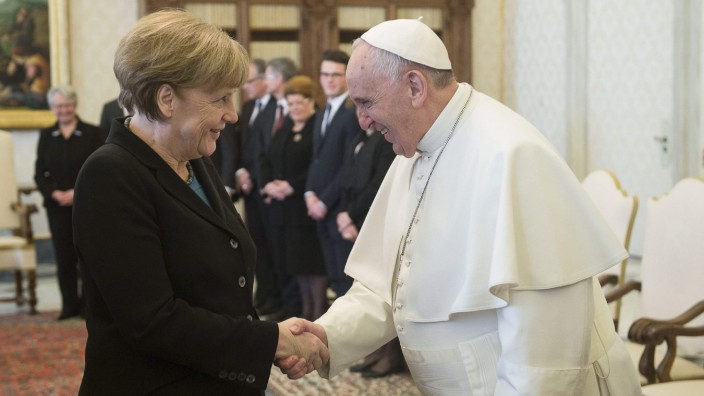 Pope Francis shakes hands with German Chancellor Merkel during a meeting at the Vatican