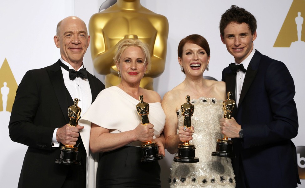 J.K. Simmons, Patricia Arquette, Julianne Moore and Eddie Redmayne pose with their Oscars backstage at the 87th Academy Awards in Hollywood, California