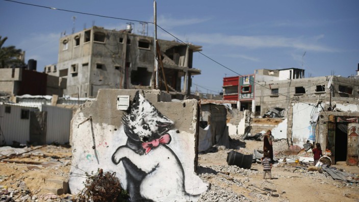 A mural of a kitten, presumably painted by British street artist Banksy, is seen on the remains of a house in Biet Hanoun