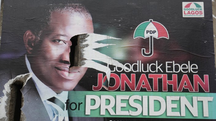 Nigeria postpones general election epa04621075 A picture made available on 15 February 2015 shows a campaign poster of incumbent presidential candidate, Goodluck Jonathan, torn apart on a street Corne