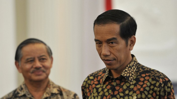 Indonesian President Widodo speaks to journalists as Indonesia's Ambassador to Brazil Riyanto looks on after a meeting to discuss the delay in Brazil's acceptance of the ambassador's credentials, in Jakarta