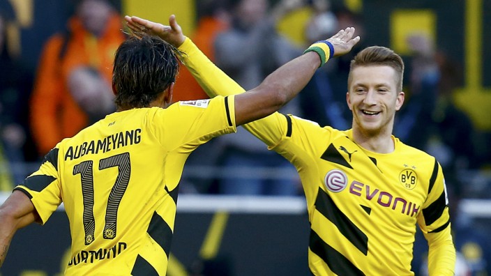 Borussia Dortmund's Aubameyang celebrates with Reus after scoring against Schalke 04's during Bundesliga soccer match in Dortmund