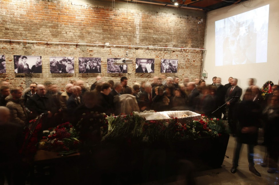 People surround the coffin as they attend a memorial service before the funeral of Nemtsov in Moscow