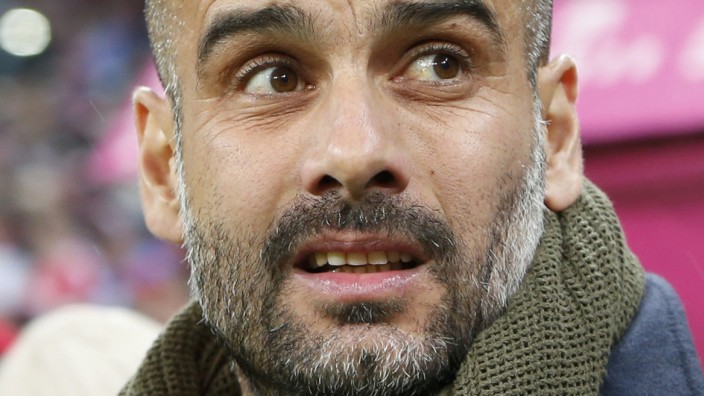 Bayern Munich's coach Guardiola stands on sidelines during Bundesliga soccer match against FC Cologne in Munich