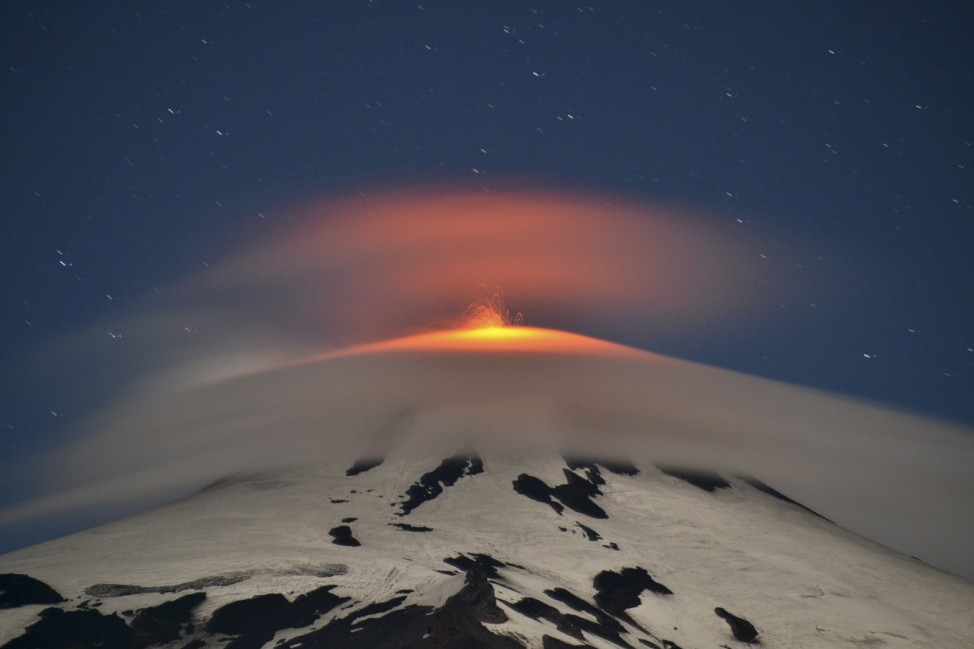 Smoke and lava spew from the Villarrica volcano as seen from Pucon town in the south of Santiago