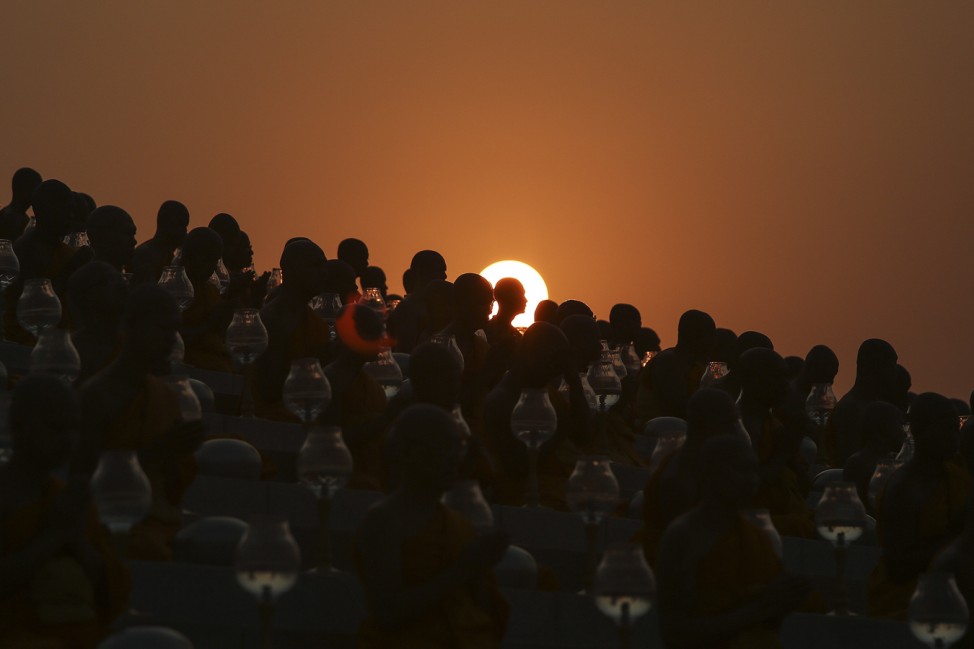 Buddhist monks prepare for an alms offering ceremony at the Wat Phra Dhammakaya temple in Pathum Thani province