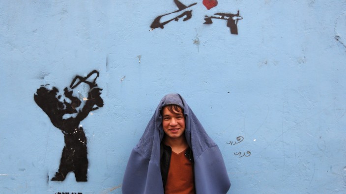 A male Afghan women's rights activist poses for pictures in burqa to show solidarity to Afghan women ahead of International Women's Day in Kabul