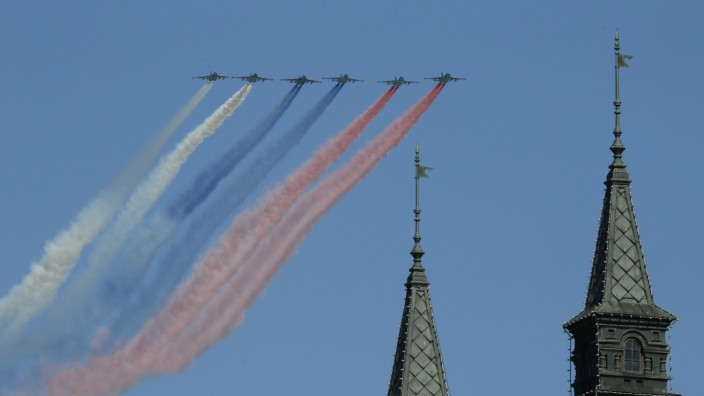 Russian military aircraft trail smoke in the colours of the Russian tricolor above the Victory Day Parade in Moscow's Red Square