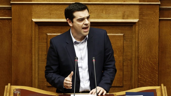 Greek PM Tsipras addresses lawmakers during a parliamentary session for the creation of a committee for claiming World War II war reparations at the parliament building in Athens