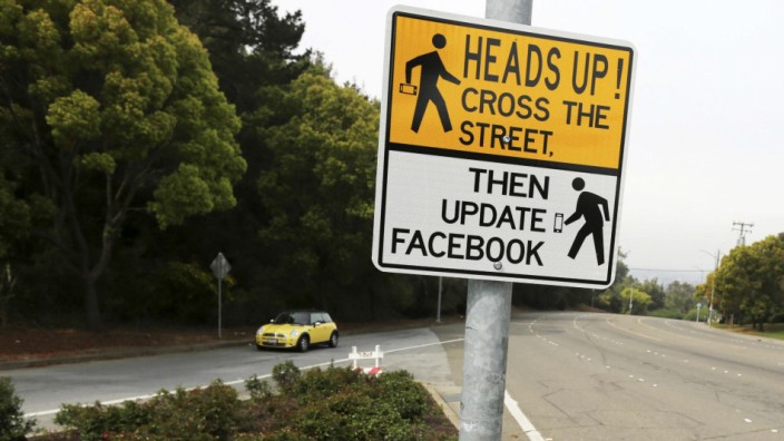 A sign is shown at a crosswalk near California State University in Hayward, California