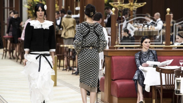 Models present creations by German designer Karl Lagerfeld as part of his Autumn/Winter 2015/2016 women's ready-to-wear collection show for French fashion house Chanel during Paris Fashion Week