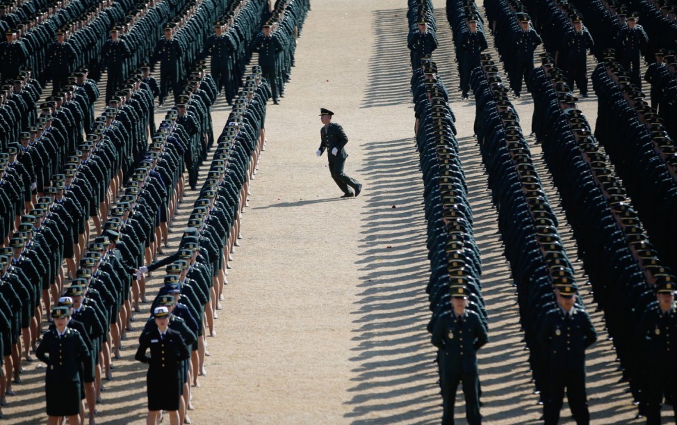 A new South Korean military officer runs into an echelon as they attend a joint commissioning ceremony for 6,478 new officers from the Army, Navy, Air Force and Marines at the military headquarters in Gyeryong