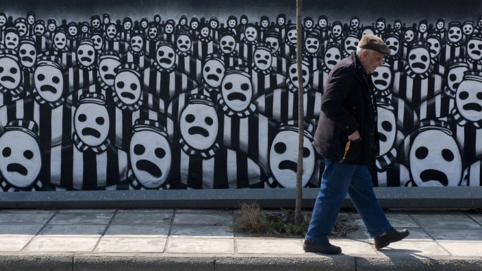 A man walks past a graffiti dedicated to the Holocaust in the northern port city of Thessaloniki