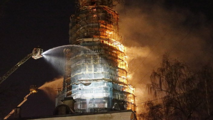 Firefighters work to extinguish a fire at the bell tower of Novodevichy monastery in Moscow