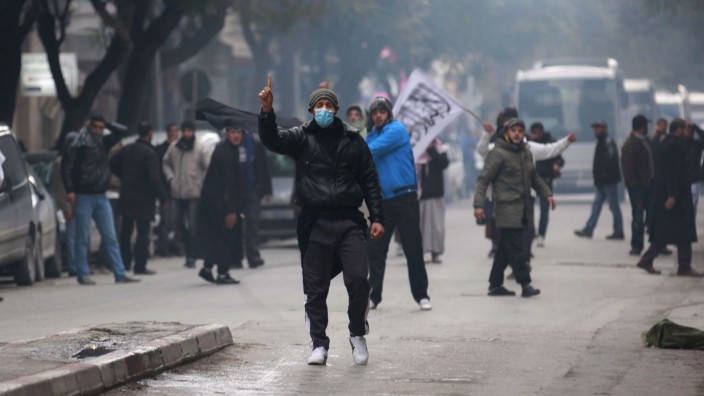 Protesters gesture as they shout 'Allahu Akbar' (God is Greatest) during a demonstration, in Tunis
