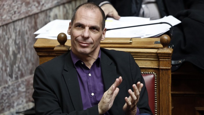 Greek Finance Minister Varoufakis applauds during a parliamentary session in Athens