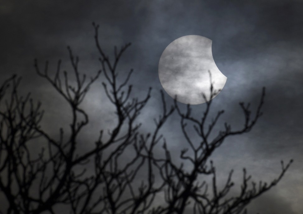A partial solar eclipse is seen from near Bridgwater, in south western England