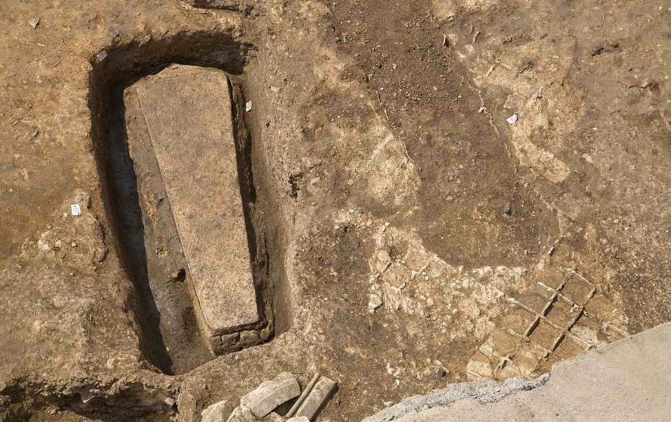 University of Leicester handout photo shows a stone coffin before its lid is removed at the Greyfriars dig site