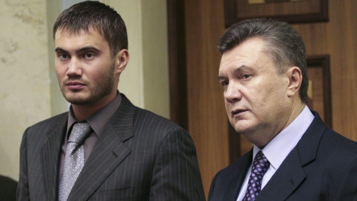 Ukrainian politician Viktor Yanukovich and his son Viktor speak inside the parliament bulding in Kiev