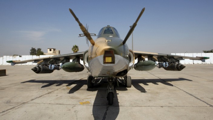 A Sukhoi Su-25 aircraft loaded with bombers is seen at an air base in Baghdad