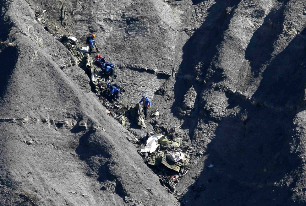 French gendarmes and investigators work amongst the debris of the Airbus A320 at the site of the crash, near Seyne-les-Alpes, French Alps