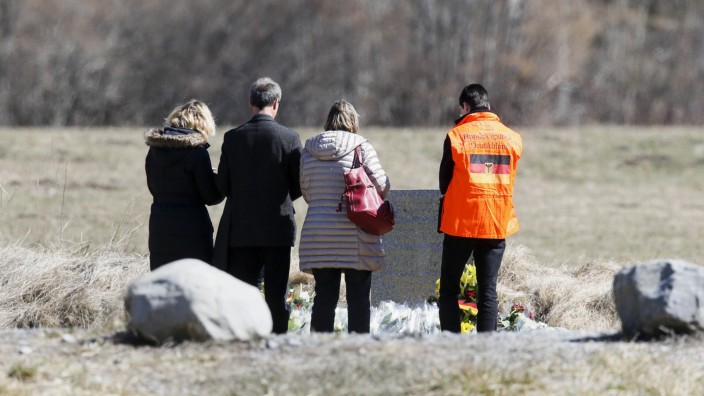 People pay their respects at the memorial for the victims of the air disaster in the village of Le Vernet, near the crash site of the Airbus A320 in French Alps