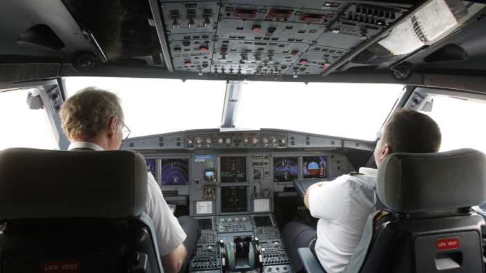 Pilots sit at the cockpit of a VietJet  A320 airplane before departure for Bangkok in this file photo