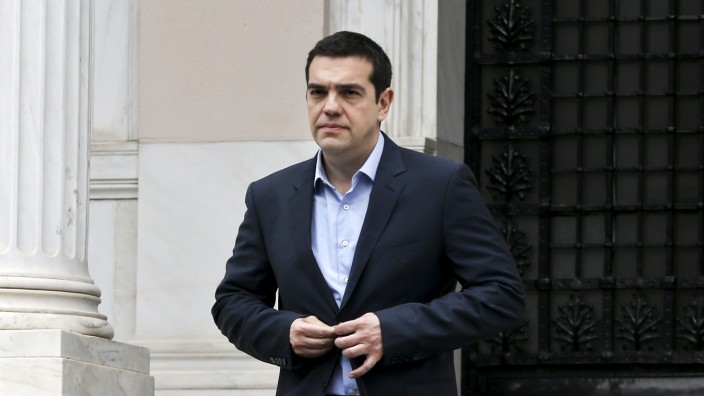 Greek PM Tsipras leaves his office in Maximos Mansion after a meeting with his government's financial staff in Athens