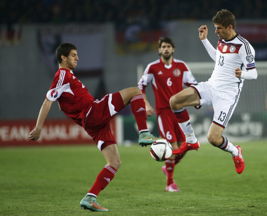 Georgia's Dvali fights for ball with Germany's Mueller during their Euro 2016 qualifier soccer match in Tbilisi