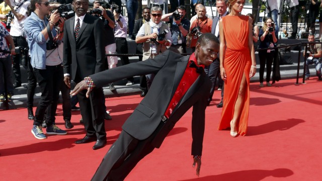 Cast member Souleymane Deme performs on the red carpet as he arrives for the screening of the film 'Grigris' in competition during the 66th Cannes Film Festival
