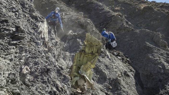 Nach Flugzeugabsturz 4U9525: Schwierige Räumarbeiten: Helfer bergen ein Trümmerteil am Absturzort von Flug 4U9525 in Frankreich.