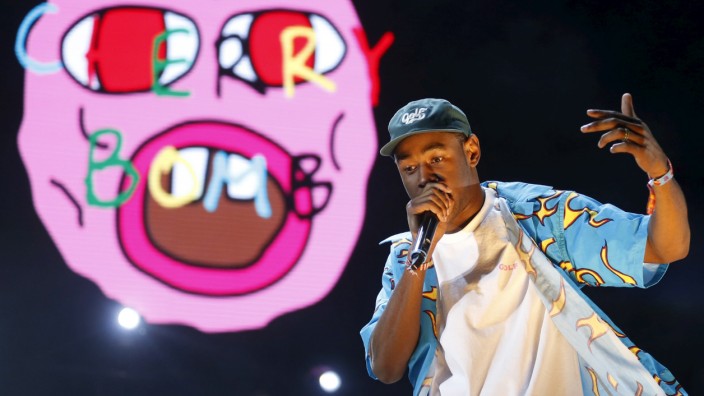 Tyler the Creator performs on a stage set giant bed at the Coachella Valley Music and Arts Festival in Indio