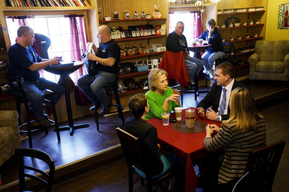 Former U.S. Secretary of State Clinton talks with local residents as she campaigns at the Jones Street Java House in LeClaire, Iowa