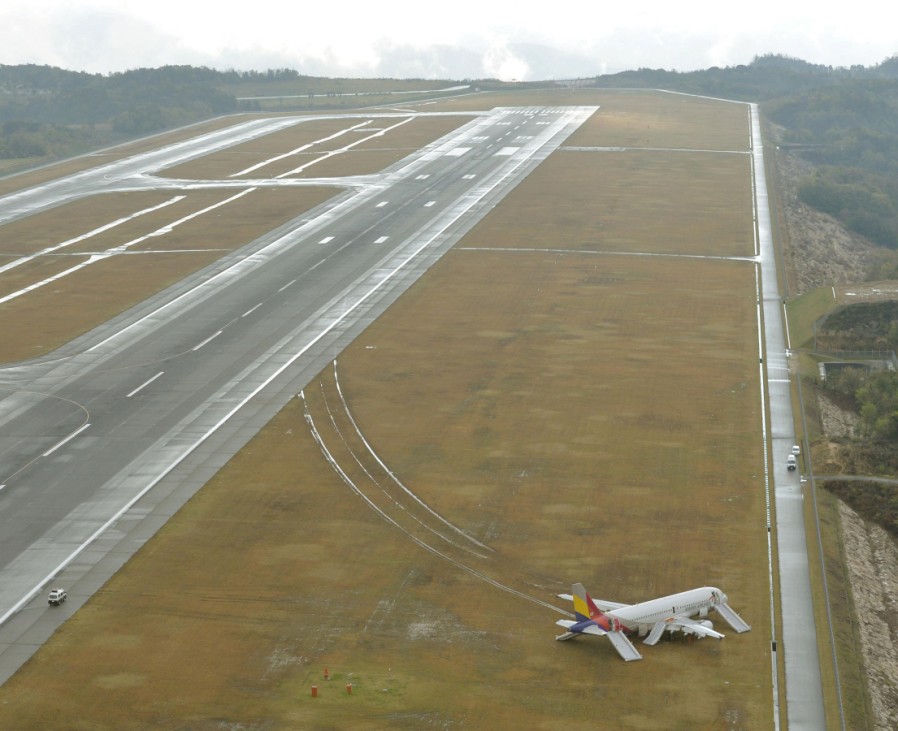 An aerial view shows an Asiana Airlines airplane which ran out of runway after landing at Hiroshima airport in Mihara