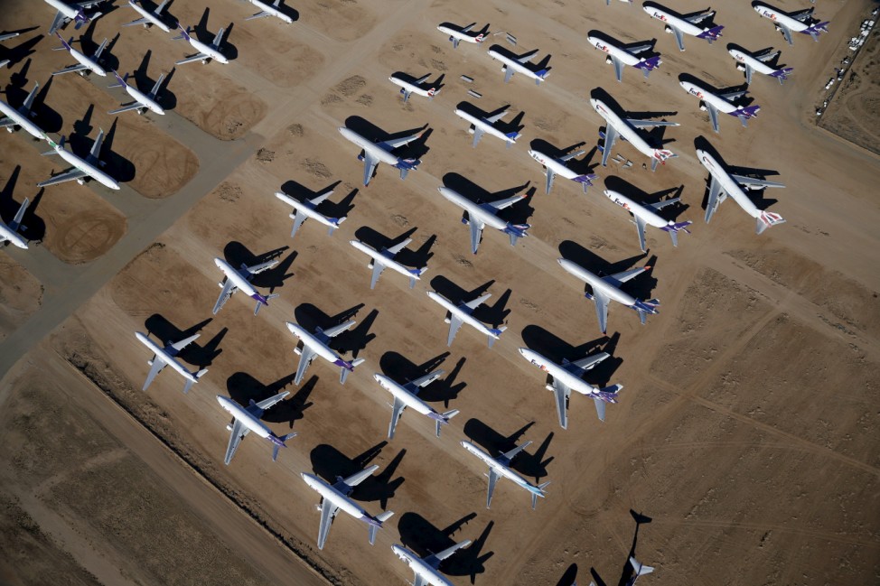 Old airplanes, including Boeing 747-400s, are stored in the desert in Victorville