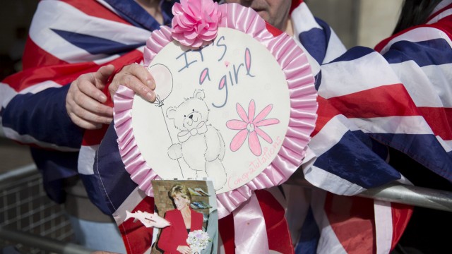 Fans of the royal family hold a rosette saying 'it's a girl' outside the Lindo Wing of St Mary's hospital in London