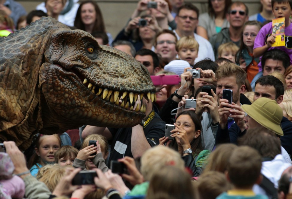 Visitors photograph an animatronic Tyrannosaurus Rex at the reopening of the National Museum of Scotland after its three-year £47 million redevelopment in Edinburgh; Dinosaurs
