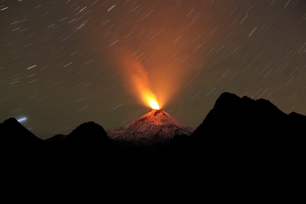 Smoke and lava spew from the Villarrica volcano, as seen from Pucon town in the south of Santiago