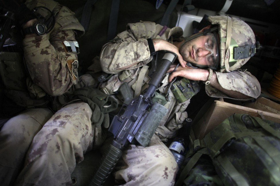 Canadian soldier takes a nap after taking part in a search operation for improvised explosive devices in Kandahar