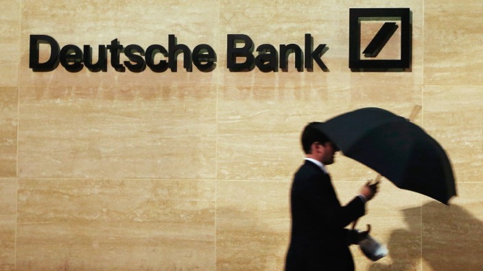 File photo of man walking past Deutsche Bank offices in London; .