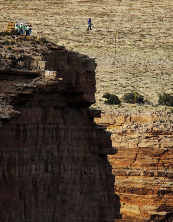 Daredevil Wallenda walks on a steel cable rigged across more than a quarter-mile deep remote section of the Grand Canyon near Little Colorado River
