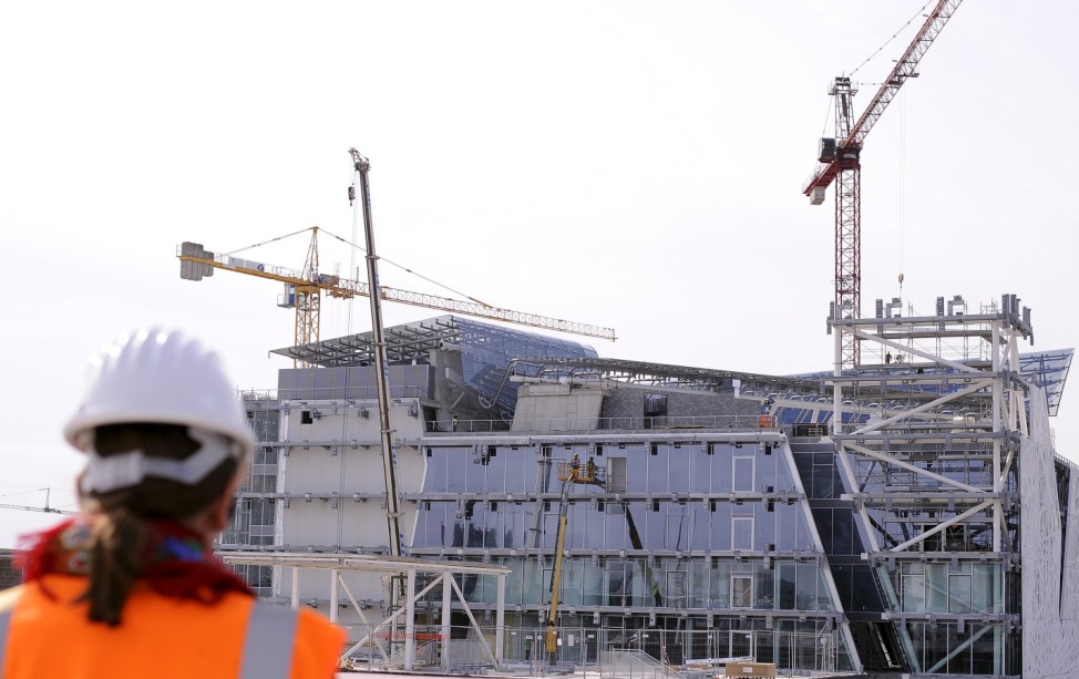 Workers work on the Italian pavilion at the Expo 2015 work site near Milan