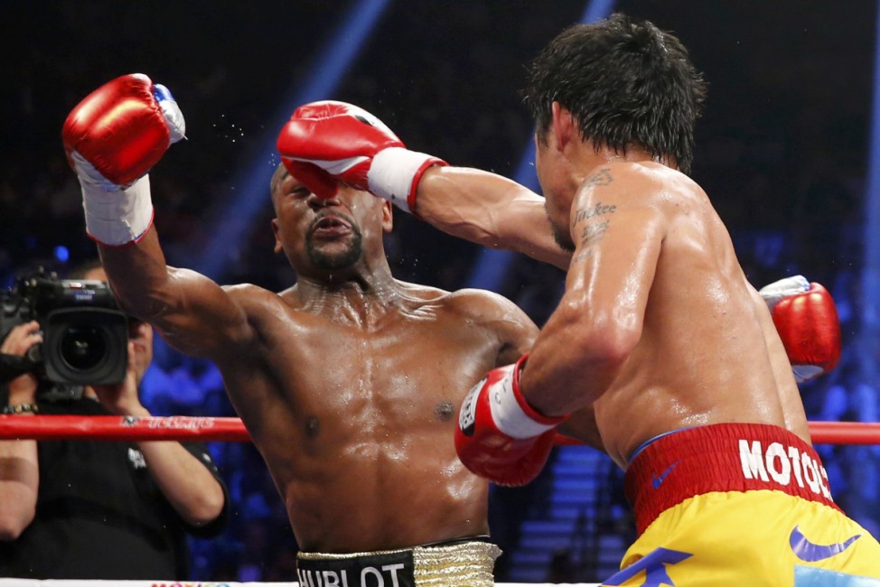 Pacquiao of the Philippines lands a right against Mayweather, Jr. of the U.S. in the fifth round during their welterweight title fight in Las Vegas
