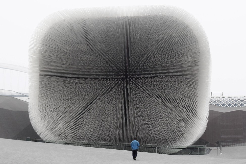 A labourer walks towards the UK pavilion at the Shanghai World Expo site