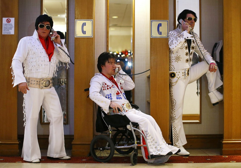 Amateur contestants pose in telephone booths during the annual European Elvis Tribute Artist Contest and Convention in Birmingham; elvis